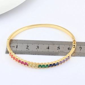 18k gold plated oval hinge bangle featuring colorful cubic zirconia stones and 60mm diameter