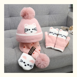 Detail of pink knitted baby winter set with fleece lining and cute white cat patterns