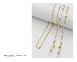 Close-up of gold metal eyewear chain with rhinestones and silicone anti-slip loops
