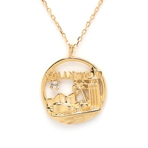 Detail of gold S925 silver Hollywood pendant featuring a palm tree and crystal