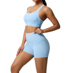 Light blue two-piece yoga set featuring high-impact sports bra and side-pocket shorts