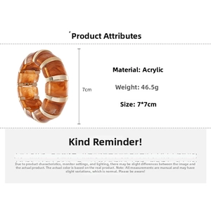 Detailed view of acrylic amber marbled bracelet with gold metal dividers and 7cm dimensions