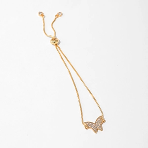 Macro detail of gold-plated butterfly bracelet with white zircon and adjustable box chain