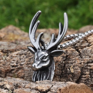 Retro stainless steel sika deer pendant necklace displayed on a rustic wood log