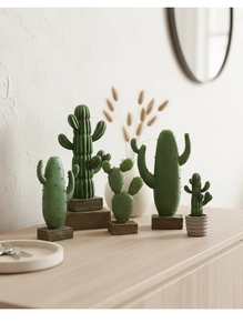 Detail of five Nordic resin cacti with realistic textures on a light wood cabinet surface