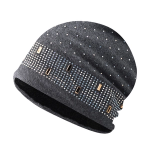 Detail of dark grey knit beanie featuring rhinestones and plush fleece lining