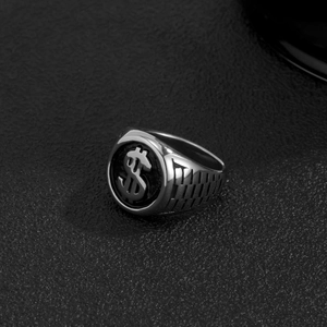 Macro shot of silver hip hop ring with dollar sign and watch strap texture on leather