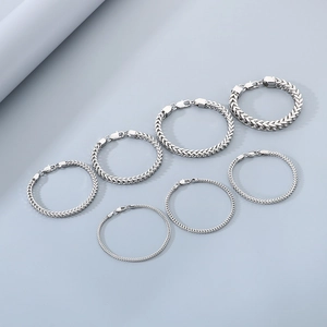 Set of seven silver stainless steel dragon bone chain bracelets in various widths