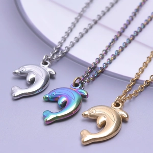 Close-up of dolphin necklaces in silver, gold, and rainbow finishes on a clean background