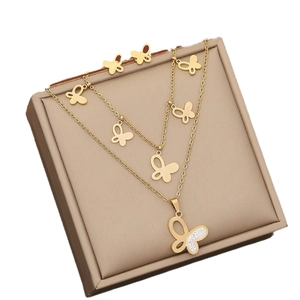 Double-layered golden butterfly jewelry set with sparkling rhinestones and matching studs
