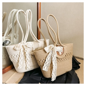 Close-up of woven tote bags with lace bow accents and pearl details in neutral tones