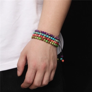 Detailed close-up of four natural 6mm tiger eye stone beaded bracelets on male wrist