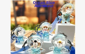 Detail of ocean blue astronaut liquid keychain with mini space figure and silicone strap