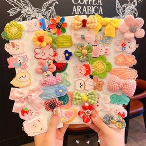 Detail showing various colorful children hair clip sets featuring rabbits and fruit shapes