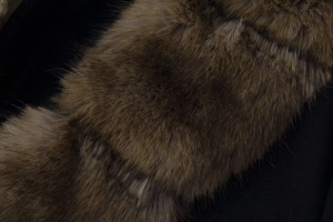 Detailed macro shot of premium faux fur collar with rich brown gradient texture