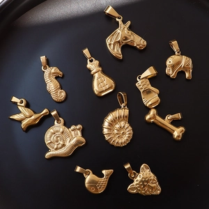 Collection of assorted animal pendants in 18K gold plated stainless steel on black tray