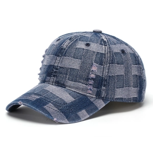 Close-up of woven denim fabric with distressed frayed details on a vintage baseball cap