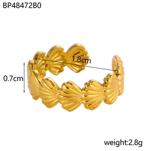 Detail view of gold seashell ring showing 0.7cm height and polished shell textures