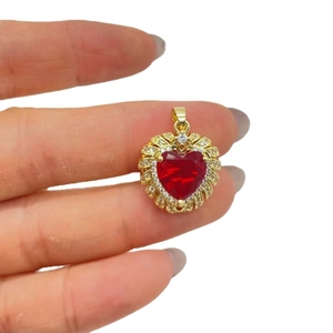 Gold-plated heart pendant with large red gemstone and sparkling cubic zirconia halo