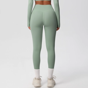 Detail view of sage green high-waisted yoga leggings showing seamless matte fabric texture