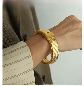 Macro detail of men's gold Tubogas snake-bone bracelet with textured elastic structure