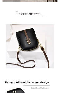 Close-up of black crossbody phone bag showing brown stripe and functional headphone jack hole