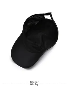Detail of the breathable mesh interior and adjustable snap closure on this black baseball cap