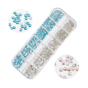 Detailed view of 12-slot box with lake blue and AB crystal glass flatback nail art rhinestones