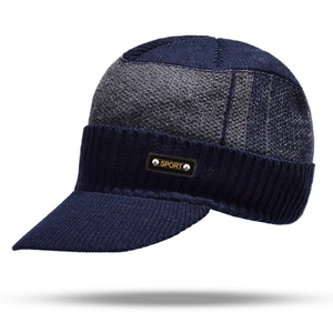 Detail of navy blue and grey knit beanie with brim featuring a leather Sport patch