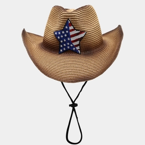 Brown straw cowboy hat with American flag star emblem and adjustable chin strap