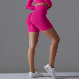 Detailed texture of seamless neon pink yoga shorts with high waist contouring design