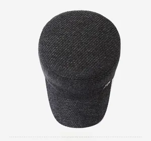 Top view of dark grey wool flat top military cap with textured knit fabric and metal logo