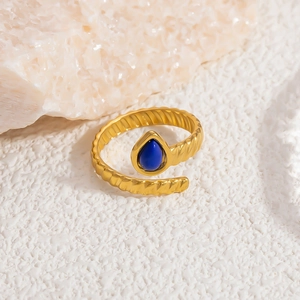Detail of 18k gold plated twist ring featuring a teardrop-shaped deep blue stone accent