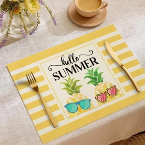 Linen placemat with pineapple print and Hello Summer text in a scenic table setting