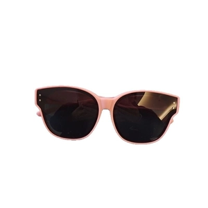 Pink retro kids sunglasses with dark lenses for sun protection on white background