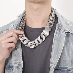 Close-up of heavy silver-colored Cuban link chain necklace on a male model