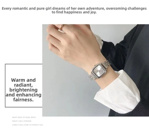 Detailed view of a silver square quartz watch with a sleek metal chain strap on wrist