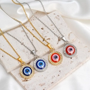 Macro shot of evil eye charms in gold and silver with colorful blue and red centers