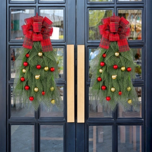 Christmas door swag with red mesh, plaid bows and gold baubles for holiday decoration
