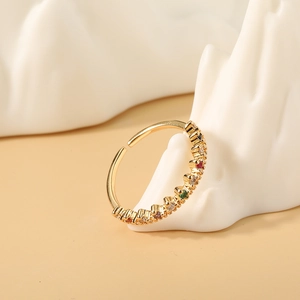 Macro shot of gold adjustable crown ring featuring vibrant colored zircon gemstones