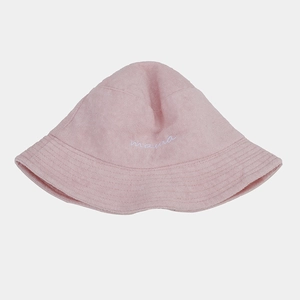 Detailed close-up of white 'mama' embroidery on a soft pink terry cloth bucket hat