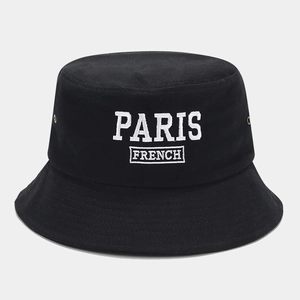Close-up of white PARIS FRENCH embroidery on a black cotton canvas bucket hat