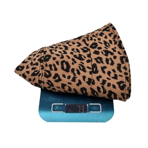 Fashionable leopard print bucket hat with wide brim, weighing 73 grams on a scale.