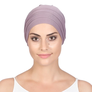 Front close-up of light purple pleated chemo turban hat in soft elastic knit fabric
