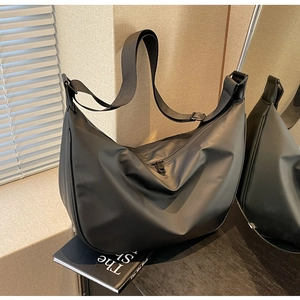 Close-up of black nylon dumpling crossbody bag with large capacity for daily commute