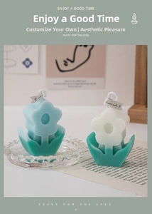 Detail of tulip-shaped scented candles in blue and cream with Scented Candles tag