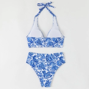 Flat lay of blue and white paisley halter bikini set with high waisted bottoms