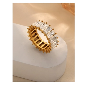 Macro view of gold-plated titanium ring with full baguette-cut zircon inlay and claw setting