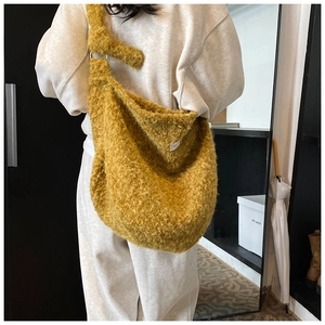 Detail of yellow fuzzy teddy wool tote bag with metal ring and soft shoulder strap
