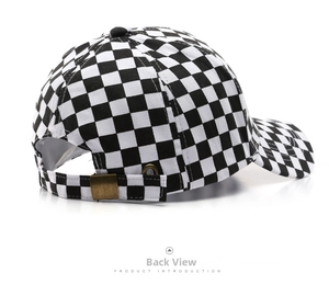 Detail of checkered baseball cap rear with adjustable strap and bronze metal buckle